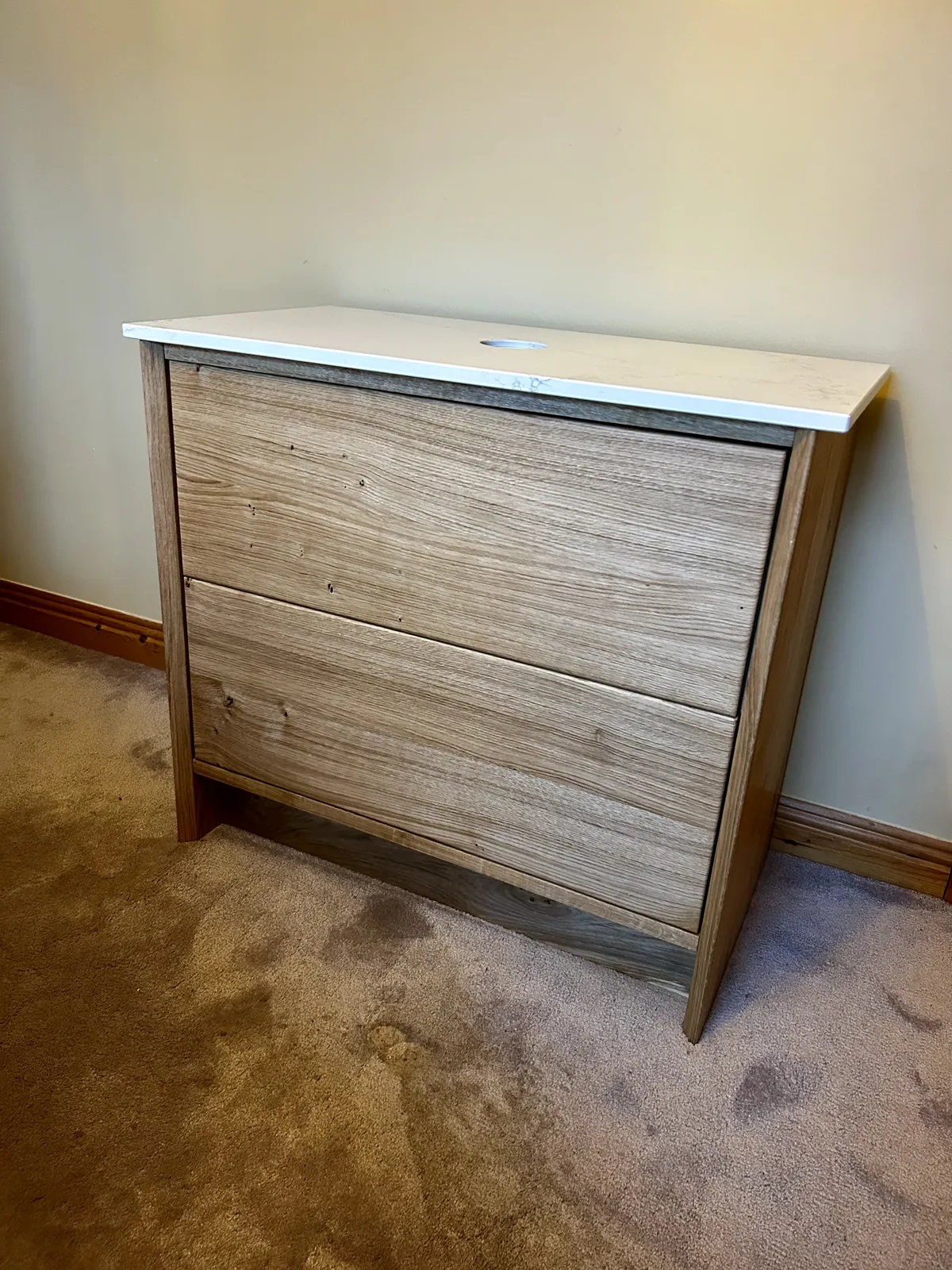 White oak vanity unit with quartz top, three-quarter view
