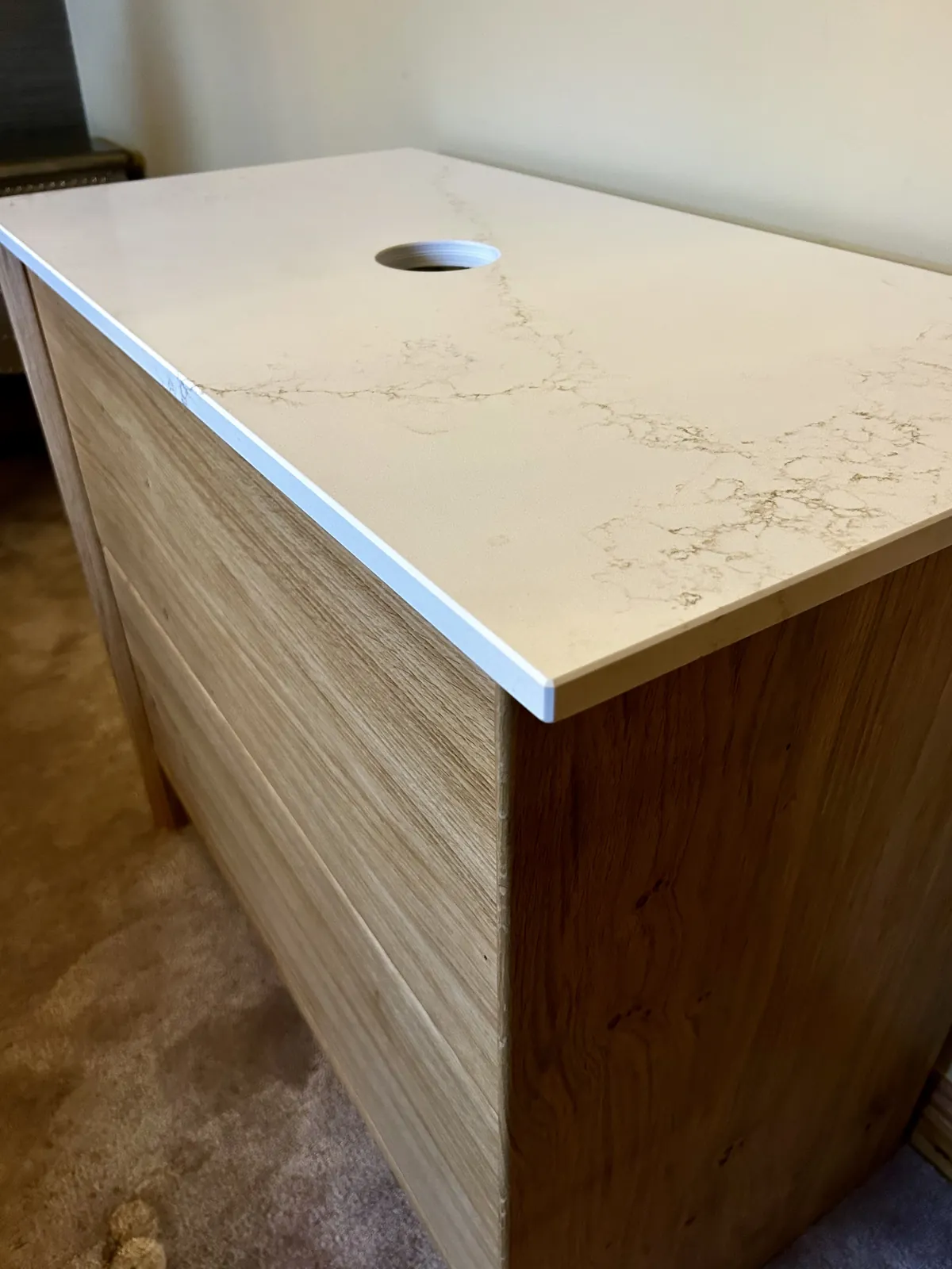 Quartz countertop with veining over solid oak vanity carcass