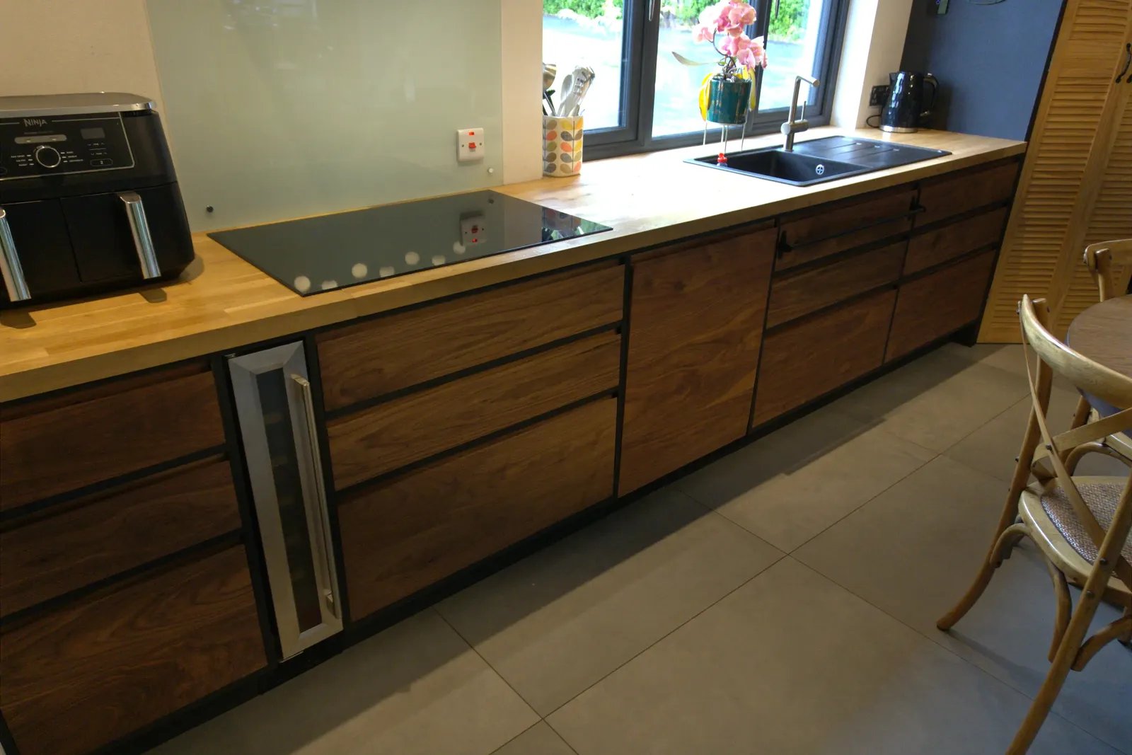 Solid walnut kitchen cabinets with a black face frame and oak worktop